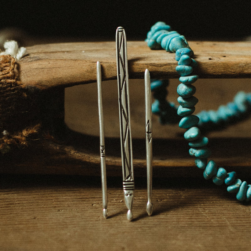 Picture of three silver shonishin tools with turquoise beaded necklace